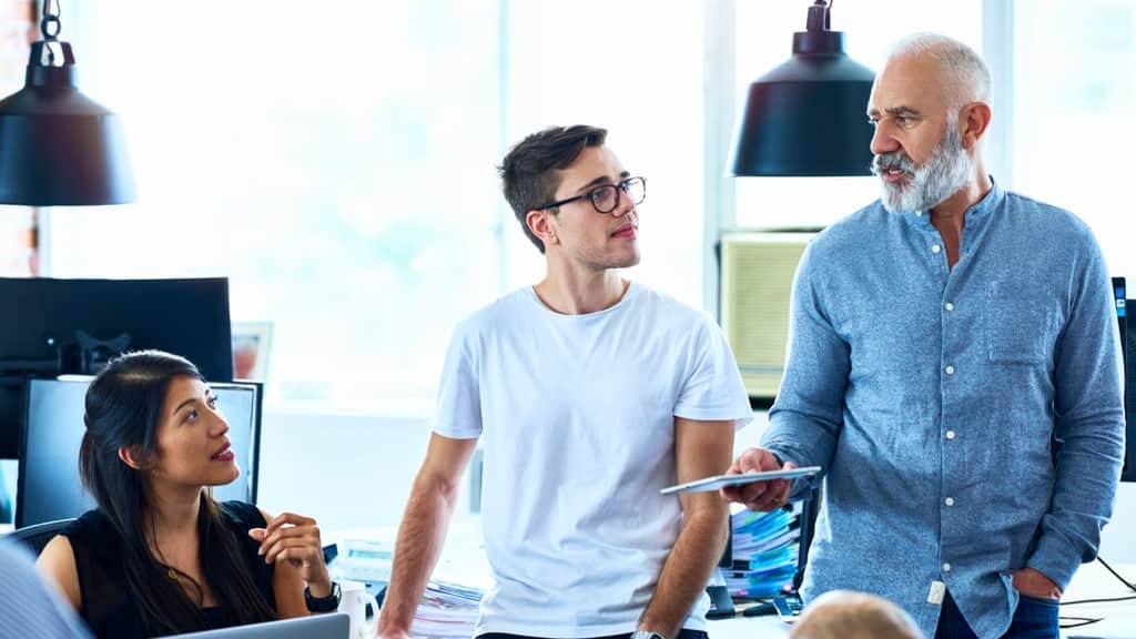 Several professionals discussing ideas in a collaborative office environment